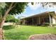 A backyard view shows a home with a screened porch and green grass with trees at 1670 Palmwood Dr, Clearwater, FL 33756