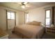 Bright bedroom features two windows, a ceiling fan, a comfortable bed, and side tables at 1670 Palmwood Dr, Clearwater, FL 33756