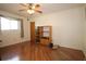A naturally lit bedroom features hardwood floors, ceiling fan, and built-in shelving at 1670 Palmwood Dr, Clearwater, FL 33756