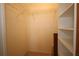 Walk-in closet with metal shelving and neutral-colored carpet at 1670 Palmwood Dr, Clearwater, FL 33756