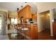 Cozy kitchen with wooden cabinets, granite countertops, and a bar area with seating for casual dining at 1670 Palmwood Dr, Clearwater, FL 33756