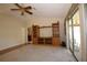 Bright living area featuring neutral walls, built-in shelving, and a sliding glass door offering outdoor views at 1670 Palmwood Dr, Clearwater, FL 33756