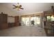 Open concept living room with a kitchen bar, vaulted ceilings, an entertainment center, and sliding glass doors to the patio at 1670 Palmwood Dr, Clearwater, FL 33756