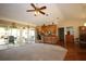 View of a living space flowing into the kitchen featuring bar seating and sliding door access to the sunroom at 1670 Palmwood Dr, Clearwater, FL 33756