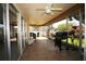 Enclosed sunroom with tiled flooring, a ceiling fan, outdoor furniture, and a grill perfect for outdoor entertaining at 1670 Palmwood Dr, Clearwater, FL 33756
