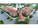 Aerial view of community center featuring a resort-style pool, amenities, and lush landscaping at 16913 Clear Cork Dr, Wimauma, FL 33598