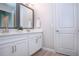 Bright bathroom features double vanity with white cabinets and a large mirror at 16913 Clear Cork Dr, Wimauma, FL 33598