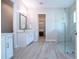 Modern bathroom featuring a glass enclosed shower, a large vanity with lots of storage, and wood-look floors at 16913 Clear Cork Dr, Wimauma, FL 33598