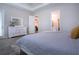 Bright bedroom features a door to the bathroom, neutral paint, carpet flooring, and a large dresser at 16913 Clear Cork Dr, Wimauma, FL 33598