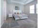 Bright bedroom features a tray ceiling, neutral paint, carpet flooring, and large windows with blinds at 16913 Clear Cork Dr, Wimauma, FL 33598