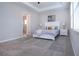 Bright bedroom features a tray ceiling, neutral paint, carpet flooring, and large windows with blinds at 16913 Clear Cork Dr, Wimauma, FL 33598