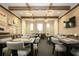 Well-appointed card room featuring tables, chairs, bright lighting, and a TV for entertainment at 16913 Clear Cork Dr, Wimauma, FL 33598