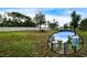 Well-maintained dog park featuring lush green grass, mature trees, and a secure fenced area at 16913 Clear Cork Dr, Wimauma, FL 33598