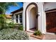 An arched entryway with brick pavers that leads to the home's front door at 16913 Clear Cork Dr, Wimauma, FL 33598