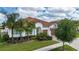 Inviting single-story home boasting a tile roof, double garage, and mature palm trees at 16913 Clear Cork Dr, Wimauma, FL 33598