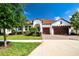 Charming single-story home with a well-manicured lawn, lush landscaping, and a brick-paved driveway at 16913 Clear Cork Dr, Wimauma, FL 33598