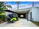 Bright green golf cart parked on a smooth path in front of a pedestrian tunnel at 16913 Clear Cork Dr, Wimauma, FL 33598