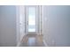 Hallway with gray walls, wood-look tile floors, and a door with a window to let in natural light at 16913 Clear Cork Dr, Wimauma, FL 33598