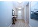 Bright hallway featuring wood floors, elegant lighting fixtures, and tasteful decor at 16913 Clear Cork Dr, Wimauma, FL 33598
