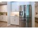 Kitchen area featuring a stainless steel refrigerator and matching white cabinetry at 16913 Clear Cork Dr, Wimauma, FL 33598