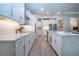 Bright kitchen features white cabinets, stainless steel appliances, modern countertops, and tile flooring at 16913 Clear Cork Dr, Wimauma, FL 33598