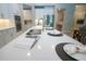 Kitchen island with a double sink, breakfast bar, and elegant countertops and cabinetry at 16913 Clear Cork Dr, Wimauma, FL 33598