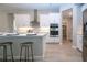 Bright kitchen showcasing white cabinetry, stainless steel appliances and built-in pantry access at 16913 Clear Cork Dr, Wimauma, FL 33598