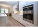 Kitchen area featuring matching white cabinetry, stainless steel microwave and oven at 16913 Clear Cork Dr, Wimauma, FL 33598