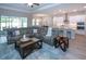 Open-concept living space showcasing a large sectional sofa and seamless flow to the kitchen at 16913 Clear Cork Dr, Wimauma, FL 33598