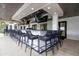 Covered outdoor bar area with a long counter, bar stools, and multiple televisions for entertainment at 16913 Clear Cork Dr, Wimauma, FL 33598