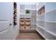 Pantry closet features a variety of shelves, baskets, and space for wine storage at 16913 Clear Cork Dr, Wimauma, FL 33598
