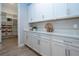 Walk-in pantry with white shelving and cabinet space for organized storage at 16913 Clear Cork Dr, Wimauma, FL 33598