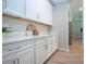 Butler's pantry with matching white cabinets and stone countertops at 16913 Clear Cork Dr, Wimauma, FL 33598