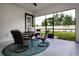 Screened patio with outdoor seating, a ceiling fan, and a view of the well-maintained backyard at 16913 Clear Cork Dr, Wimauma, FL 33598