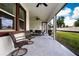 Covered patio featuring wicker chairs, an outdoor table, and a ceiling fan for comfortable outdoor living at 16913 Clear Cork Dr, Wimauma, FL 33598