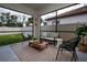 Cozy screened patio featuring stylish furniture, a coffee table, and a view of the backyard at 16913 Clear Cork Dr, Wimauma, FL 33598