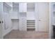 Spacious walk-in closet with custom white shelving and storage drawers provides ample storage space at 16913 Clear Cork Dr, Wimauma, FL 33598