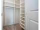Well-organized walk-in closet features built-in shelving for efficient clothing storage at 16913 Clear Cork Dr, Wimauma, FL 33598