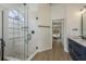 Well-designed bathroom with glass shower and double vanity, leading into main bedroom with pool view at 1793 Pipers Meadow Dr, Palm Harbor, FL 34683