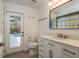 Bathroom with white marble vanity and door leading to the pool area, offering convenience and style at 1793 Pipers Meadow Dr, Palm Harbor, FL 34683