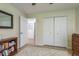 Bright bedroom with neutral walls, closet, and an open door with a mirror visible in the adjacent room at 1793 Pipers Meadow Dr, Palm Harbor, FL 34683