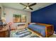 Bedroom featuring a blue accent wall, playful road-themed rug and a window that provides natural light at 1793 Pipers Meadow Dr, Palm Harbor, FL 34683