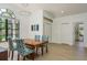 Light and airy dining area showcasing a square table with chairs, complemented by modern lighting at 1793 Pipers Meadow Dr, Palm Harbor, FL 34683