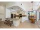 Bright kitchen featuring a breakfast bar, granite countertops, stainless steel appliances and adjacent dining area at 1793 Pipers Meadow Dr, Palm Harbor, FL 34683