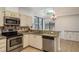 Stylish kitchen with granite countertops, stainless steel appliances, and a bright window overlooking the backyard at 1793 Pipers Meadow Dr, Palm Harbor, FL 34683