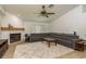 Comfortable living room featuring a large sectional sofa, fireplace, and neutral tones, creating a relaxing atmosphere at 1793 Pipers Meadow Dr, Palm Harbor, FL 34683