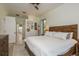Spacious main bedroom boasts modern decor and a wood bed frame, creating a cozy and inviting space at 1793 Pipers Meadow Dr, Palm Harbor, FL 34683