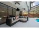 Covered patio features comfortable seating with cushions and ceiling fans at 1793 Pipers Meadow Dr, Palm Harbor, FL 34683