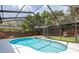 Inviting screened-in pool and spa with lush landscaping create the perfect backyard oasis at 1793 Pipers Meadow Dr, Palm Harbor, FL 34683