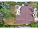 Aerial view of a large backyard featuring a gravel seating area with Adirondack chairs around a fire pit at 1807 Tawnee Pl, Brandon, FL 33510